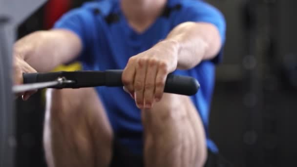 Slow Motion Sequence Man Gym Exercising Rowing Machine — Stock Video