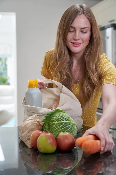 Woman Returning Home From Shopping Trip Unpacking Plastic Free G