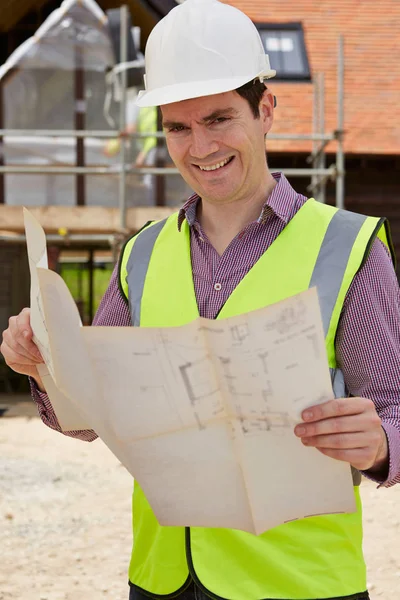 Portrait Of Architect On Building Site Looking At House Plans — Stock Photo, Image