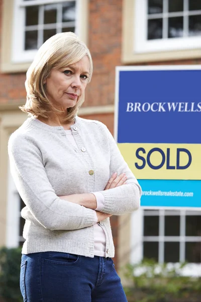 Portrait Of Unhappy Mature Woman Forced To Sell Home Through Fin — Stock Photo, Image