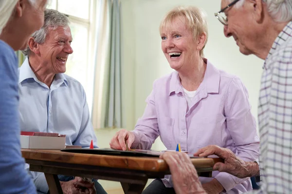 Group Of Retired Friends Playing Board Game At Social Club — Stock Photo, Image