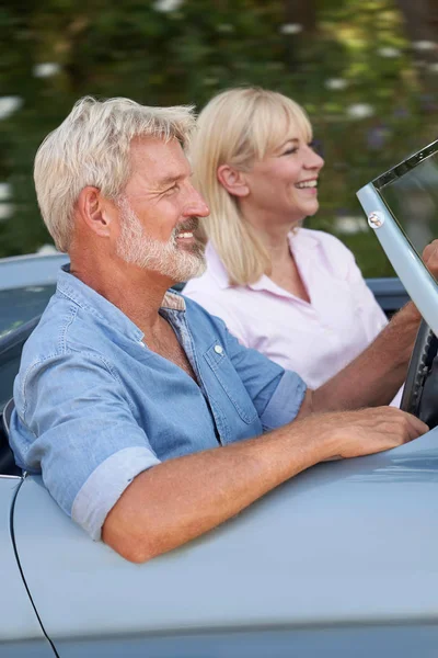 Mature Couple Enjoying Road Trip In Classic Open Top Sports Car — Stock Photo, Image