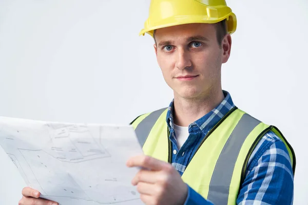 Studio Portrait Of Builder Architect Looking At Plans Against Wh — Stock Photo, Image
