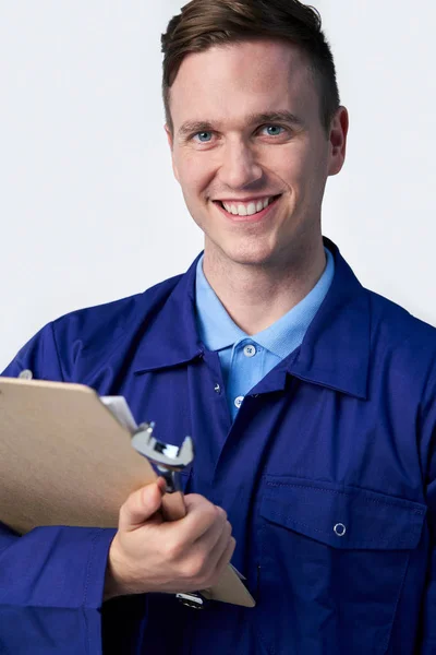 Studio Portrait Of Male Engineer With Clipboard And Spanner Agai — Stock Photo, Image