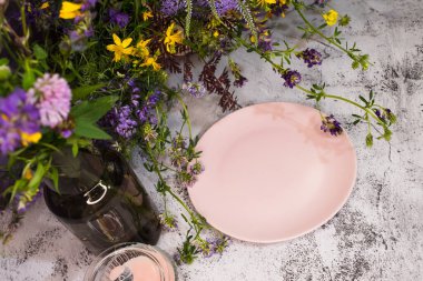 Masadaki kır çiçeklerinde boş bir tabak..
