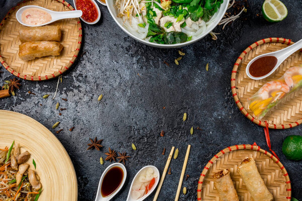 Assorted asian dinner, vietnamese food. Pho ga, pho bo, noodles, spring rolls