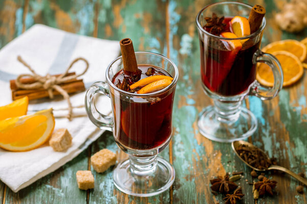 Mulled wine on old wooden background