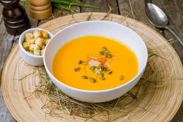 Soup cream of pumpkin with shrimps on wooden table — Stock Image Soup Cream Pumpkin Shrimps Wooden Table Royalty Free Stock Images