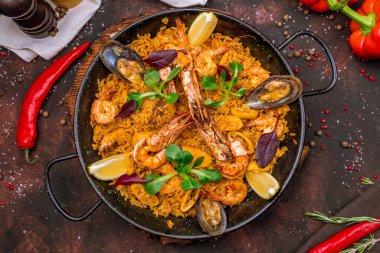 Geleneksel İspanyol paella tavasını deniz ürünleriyle kapatın.