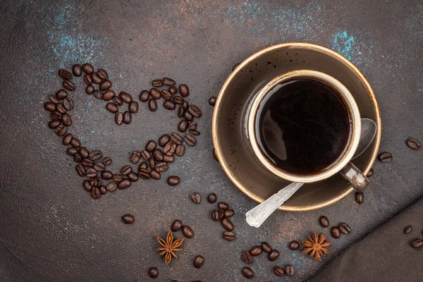 a Cup of coffee and a heart of coffee beans