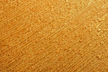 Duvarın dokusuna altın rengi boya damlaları
