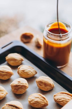 Masa arkasında kaynatılmış konsantre süt olan ev yapımı kurabiyeler. Boşluğu kopyala