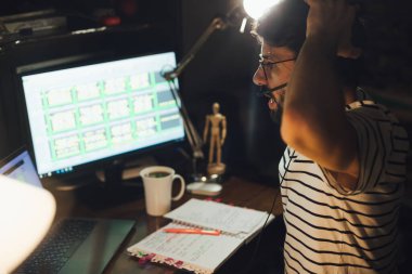 Tarz sahibi sakallı adam geceleri evden uzakta çalışıyor.