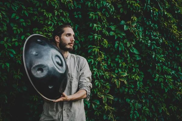 handpan in the hands of a musician. Music background for alternative contemporary music for meditation and relaxation. Copy space