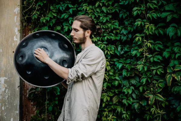 handpan in the hands of a musician. Music background for alternative contemporary music for meditation and relaxation