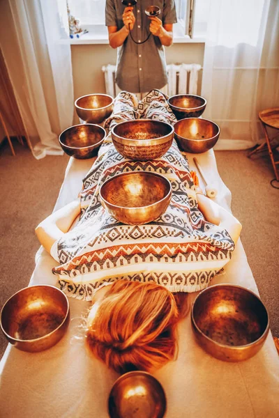 01.06.2020 Ukrayna, Vinnitsa: elinde bakır Tibet kâsesi olan sakallı bir adam. Tibet kâseleri kullanılarak yapılan meditasyon masajı.