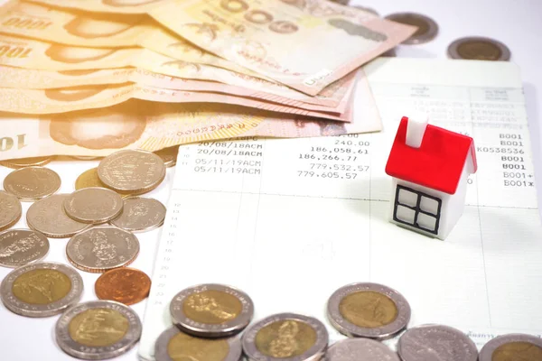 Coins , purse and house models  on white background.