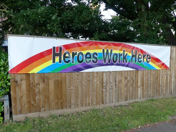 Sign outside residential care home for the elderly saying Heroes Work Here