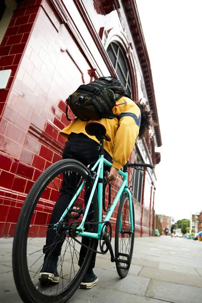 Millennial on bike in urban area. Fixed gear bike in a suburb of London.