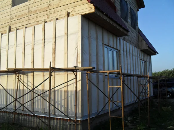 Construction of a wooden house. Wood beam, bricks. The project of a private country house.