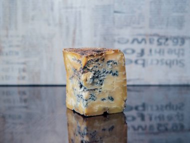 Eski, asil mavi peynir siyah bir aynada