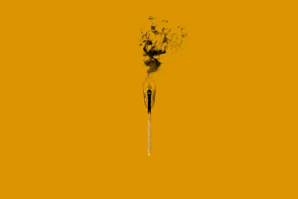 A burnt match in a drop of water on a yellow background smokes with black smoke — Stock Image Burnt Match Drop Water Yellow Background Smokes Black Smoke Stock Image