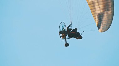 Paramotor Tandem süzülüyor ve havada uçuyor. Boşluğu kopyala