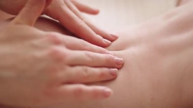 Yaklaş, anne bebeğe masaj yapıyor. yavaş çekim