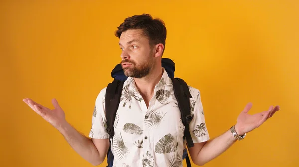 Disappointed face expression on young bearded traveler with backpack isolated — Stock Photo, Image