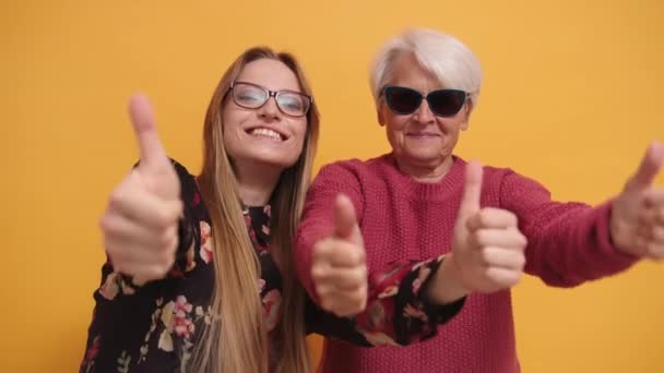 Cool moda señora mayor y mujer joven, pulgares hacia arriba. Parte estudio disparo — Vídeos de Stock