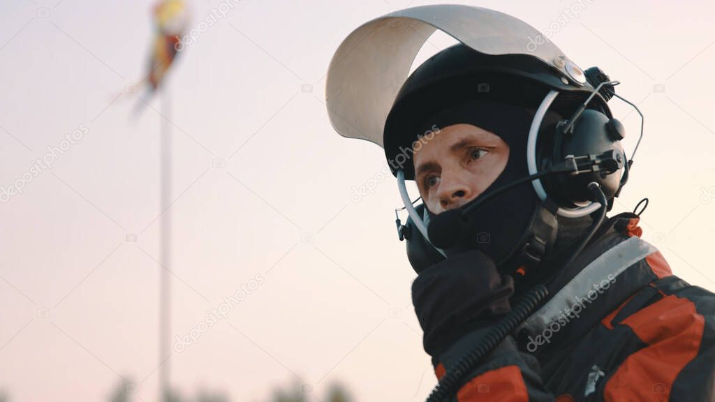 Paramotorgliding. Portrait of a man removing safety helmet after landing