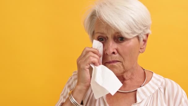 Porträt einer einsamen, traurigen, verletzlichen alten Frau, die sich die Tränen abwischt — Stockvideo