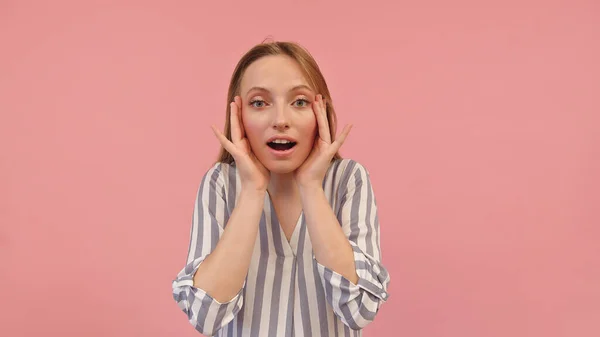 Young caucasian woman in shock holding fingertips on temples and looking on the side, isolated on pink background — Stock Photo, Image