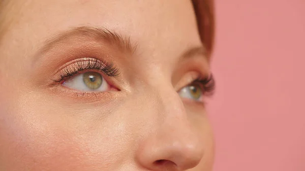 Close up of green eyes of a spy woman — Stock Photo, Image