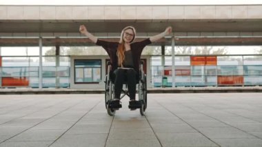 Tren istasyonundaki mutlu, genç, engelli kadın.