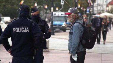 Varşova, Polonya 10.10.10.2020 - Anticovid Özgürlük Yürüyüşü - Maskesiz polis güçleriyle konuşan yaşlı adam