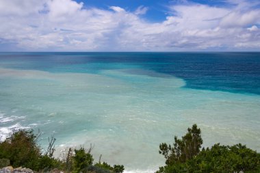 Bulutlu gökyüzüne karşı mavi deniz