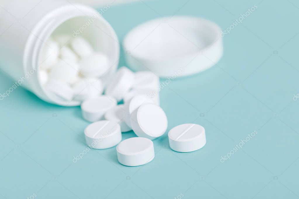 Pills spilling out of pill bottle