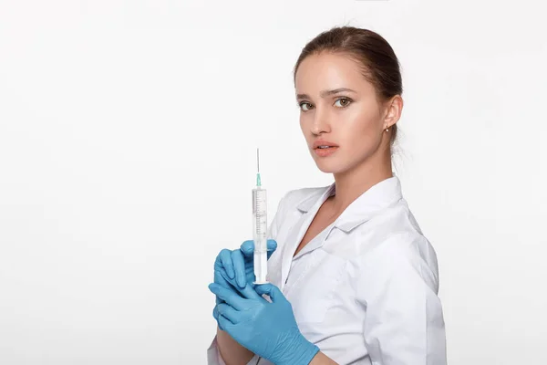 Doctor in uniform and gloves with syringe — Stock Photo, Image
