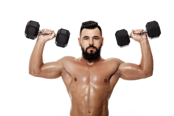 Uomo muscoloso che fa esercizi con manubri . — Foto Stock