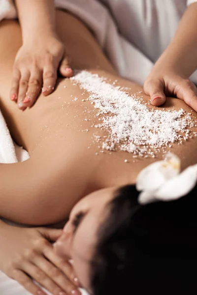 Woman receiving massage with salt peeling — Stock Photo, Image