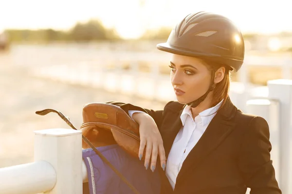 Elegant rider woman in helmet with whip — Stock Photo, Image