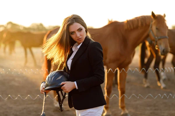 Rider woman with whip at the sunset — Stock Photo, Image