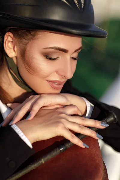 Elegant rider woman in helmet with whip — Stock Photo, Image