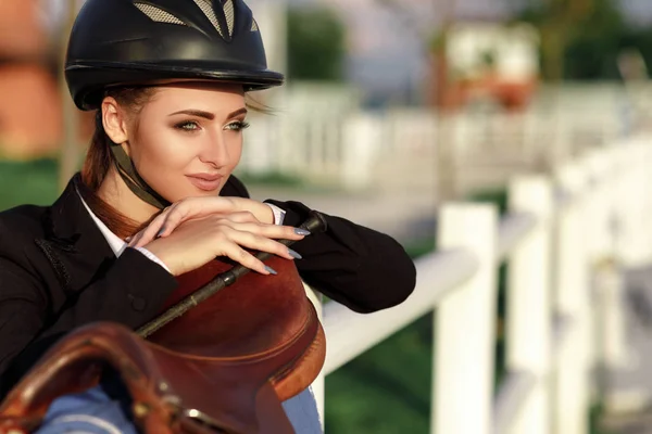 Elegant rider woman in helmet with whip — Stock Photo, Image