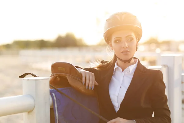 Elegant rider woman in helmet with whip — Stock Photo, Image