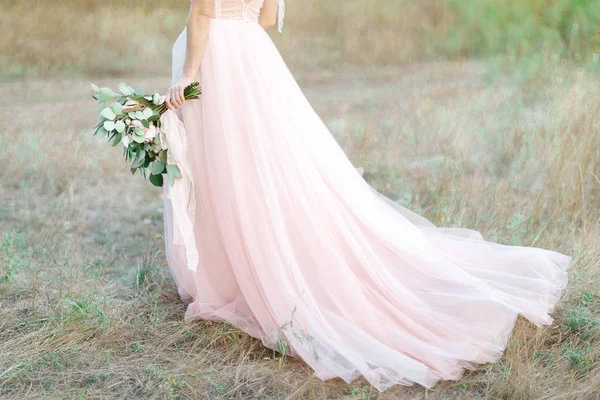 Beautiful bride with bouquet and dress with train — Stock Photo, Image