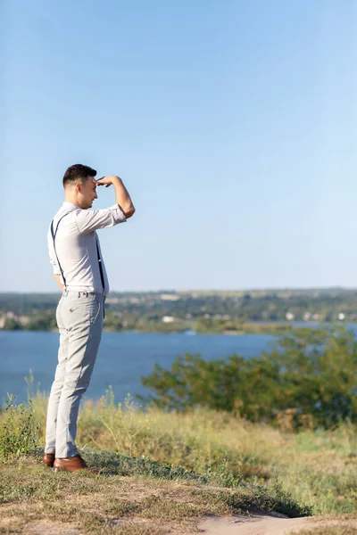 Portrait of a young handsome groom outdoors at sunset. — Stock Photo, Image