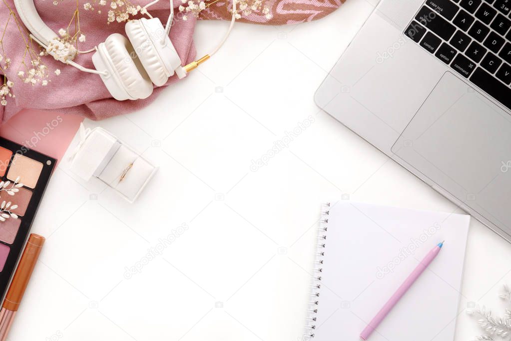 Fashion female pink accessories Set. Wedding ring in white gift box, laptop, headphones and notebook on white background.