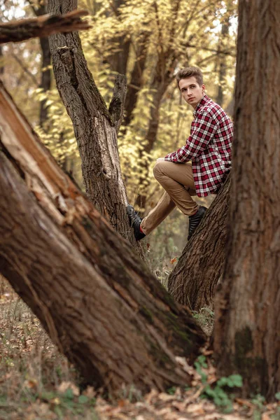 Handsome young guy in nature on an autumn day — Stock Photo, Image